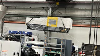 A 60-ton crane moves an injection molding machine at the Batavia, Ohio, facility of Milacron, where dozens of processing machines are currently under construction.