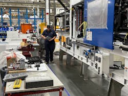 A Milacron employee works near a 275-ton press for medical molding at the company&apos;s Batavia, Ohio, plant.