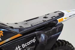 Using a new composite tape sandwich process, KTM Technologies and Engel Austria GmbH can produce motorcycle seat bases using less material and energy than traditional injection molding processes. Using a new composite tape sandwich process, KTM Technologies and Engel Austria GmbH can produce motorcycle seat bases using less material and energy than traditional injection molding processes.