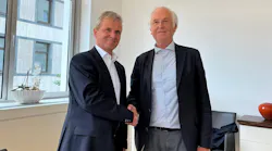 Friedrich Santner, left, and Peter Eßer, owner representative of the Brabender Group, shake hands to mark Anton Paar GmbH's successful acquisition of Brabender GmbH & Co KG.