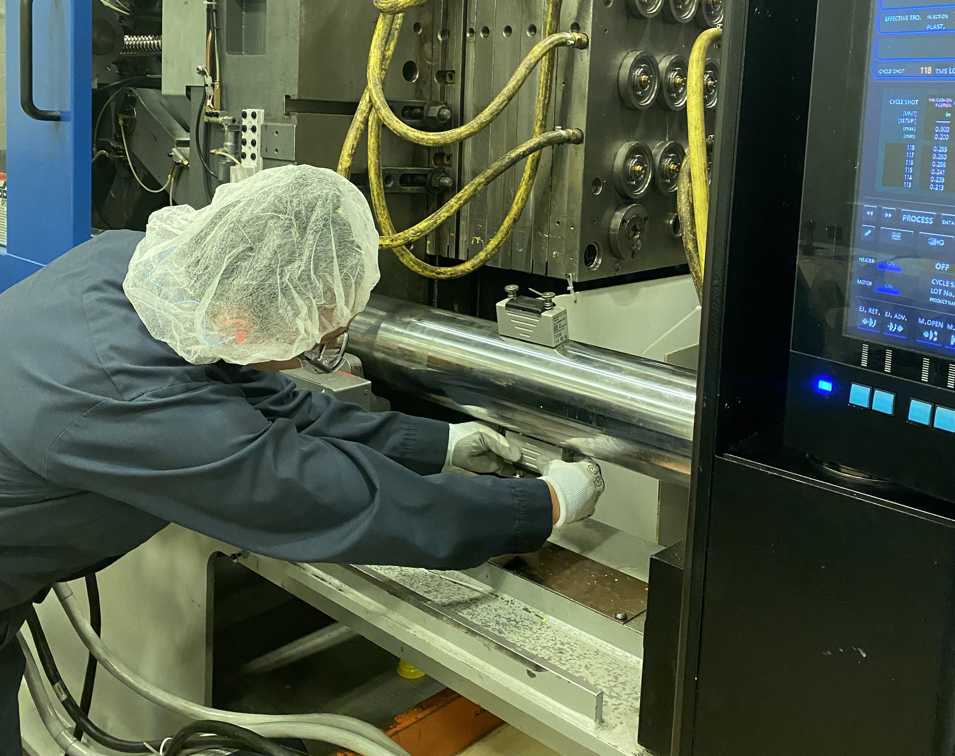 Rieke maintenance technician Ashley Williams works with Gefran QE2008-W sensors on an injection molding machine.