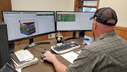 A worker studies dashboards generated by DelmiaWorks software at Augustine Plastics Inc., Somerset, Pa. A worker studies dashboards generated by DelmiaWorks software at Augustine Plastics Inc., Somerset, Pa.
