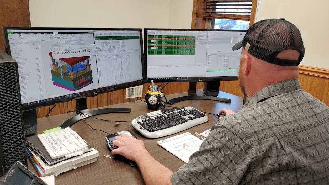A worker studies dashboards generated by DelmiaWorks software at Augustine Plastics Inc., Somerset, Pa.