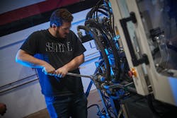 Grant Career Center student Joshua Flanigan works on a machine as part of his classes at Milacron Advanced Manufacturing Academy. Grant Career Center student Joshua Flanigan works on a machine as part of his classes at Milacron Advanced Manufacturing Academy.
