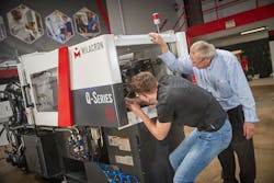 Grant Career Center student Jhace Pryor works with Daryll Martin, an instructor in the new Milacron Advanced Manufacturing Academy. Grant Career Center student Jhace Pryor works with Daryll Martin, an instructor in the new Milacron Advanced Manufacturing Academy.