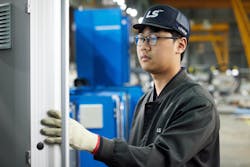 Workers build an injection molding machine at LS Mtron's factory in South Korea. Workers build an injection molding machine at LS Mtron's factory in South Korea.