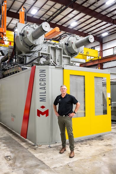 Despite standing more than 6 feet tall, 20/20 Custom Molded Plastics COO Mike Gepfert is dwarfed by the company&apos;s new 8,000-ton injection molding machine, built by Milacron.