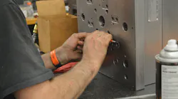 Tooling manager, Adam Cychosz performs maintenance on a mold at Anchor Plastics.