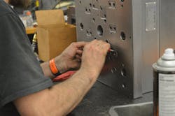 Tooling manager, Adam Cychosz performs maintenance on a mold at Anchor Plastics.