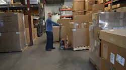 Warehouse manager Malcolm Osborne prepares to ship out a batch of fresh injection molded parts