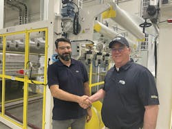 Attilio Cavagna, president of Helios Slitting, left, and Gary Kemp, aftermarket sales and services director of PTi, marked the beginning of their companies&apos; exclusive agreement to provide distribution and support for Helios slitters for sheet extrusion.