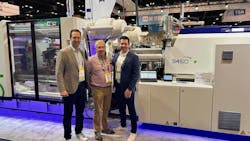 Erik Desrosiers, left, and Frank Desrosiers, right, flank their father, R&eacute;jean Desrosiers, in front of an injection molding machine at NPE. The three men co-founded ClariProd, a company now marketing a machine-monitoring system of the same name,
