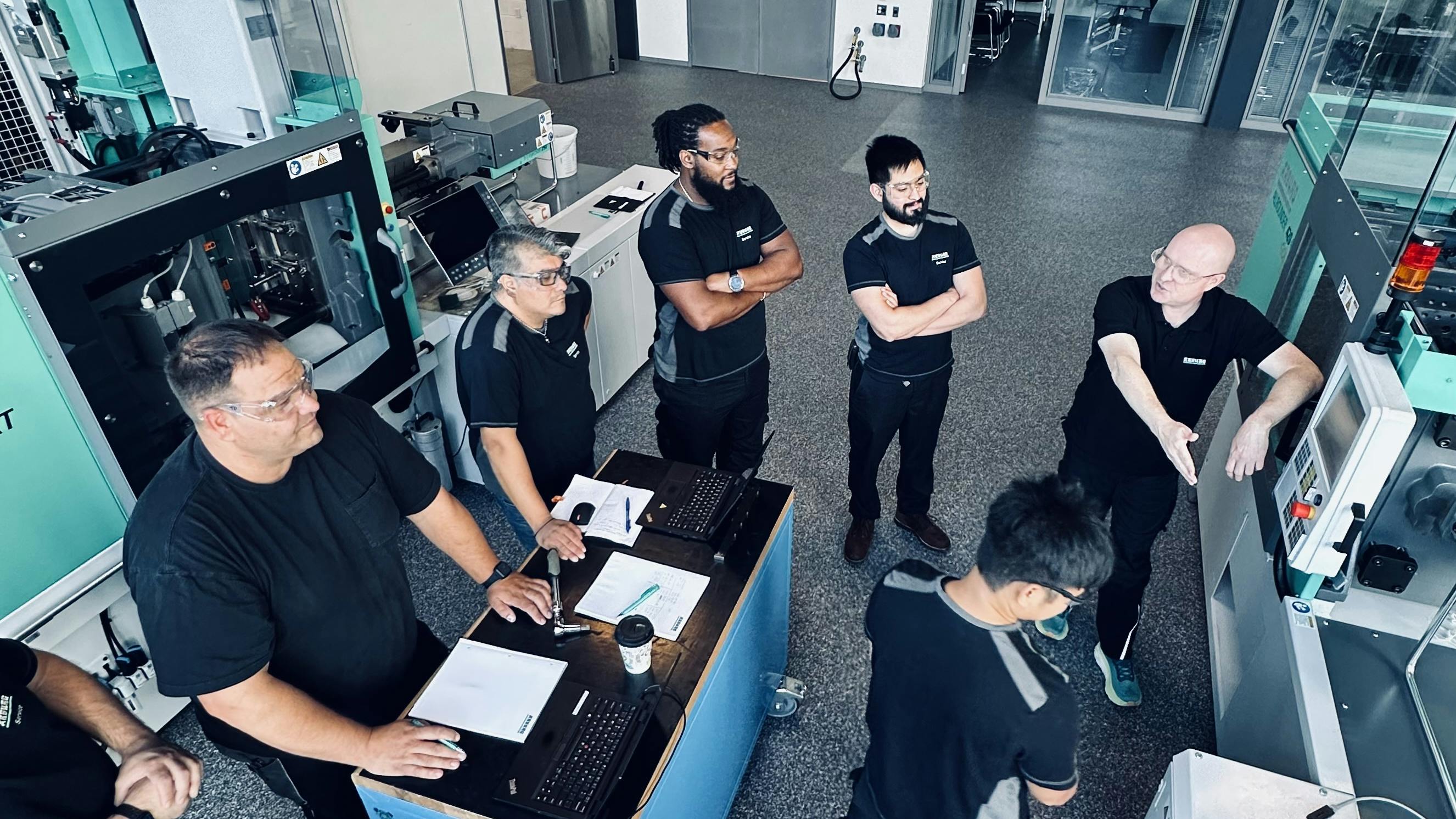 Arburg technicians meet at the company&rsquo;s Rocky, Hill, Conn., facility. The OEM's teams at its facilities in the U.S. and Germany can help customers work through processing issues, including any challenges they might be experiencing with running new or unfamiliar materials.