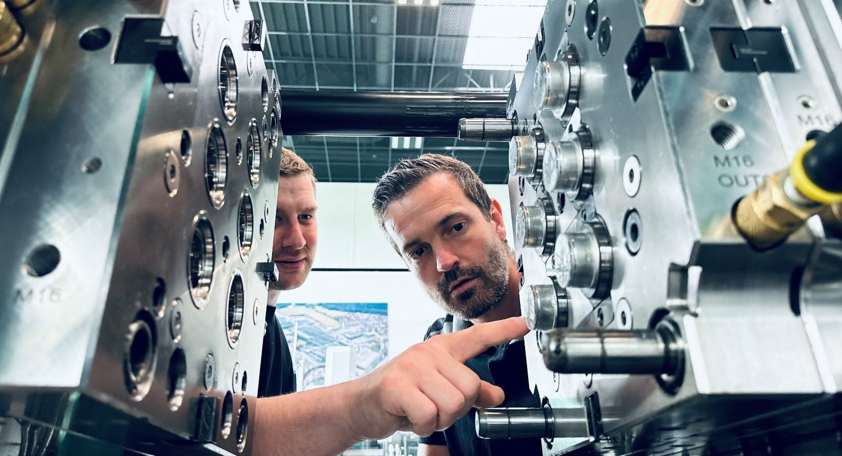 Arburg technicians work on a machine at the company&rsquo;s Rocky Hill, Conn., facility. Between that site and Arburg&rsquo;s headquarters in Germany, the company has performed more than 20 material trials for customers, helping them assess processability and optimize variables such as wall thickness. Materials that Arburg or its customers have worked with include paper, fiberglass cellulose and plant fiber.