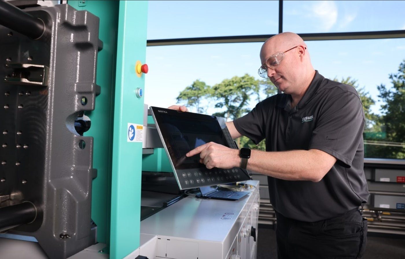 An Arburg technician works on a machine interface at the company&rsquo;s Rocky Hill, Conn., facility., where customers can collaborate with the OEM to solve issues involving new materials or other processing challenges.