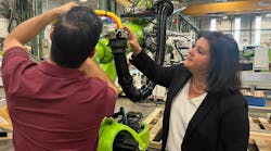 Vanessa Malena, president of Engel North America, watches a technician make adjustments to the end-of-arm-tool on an Engel robot arm. Vanessa Malena, president of Engel North America, watches a technician make adjustments to the end-of-arm-tool on an Engel robot arm.