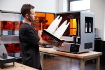 A person removes a part from a Formlabs Form 4L printer. A person removes a part from a Formlabs Form 4L printer.