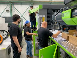Engel apprentices train on a large injection molding machine. Engel apprentices train on a large injection molding machine.