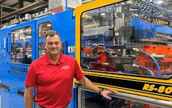 Steve Rocheleau with one of his company's extrusion blow molding machines Steve Rocheleau with one of his company's extrusion blow molding machines