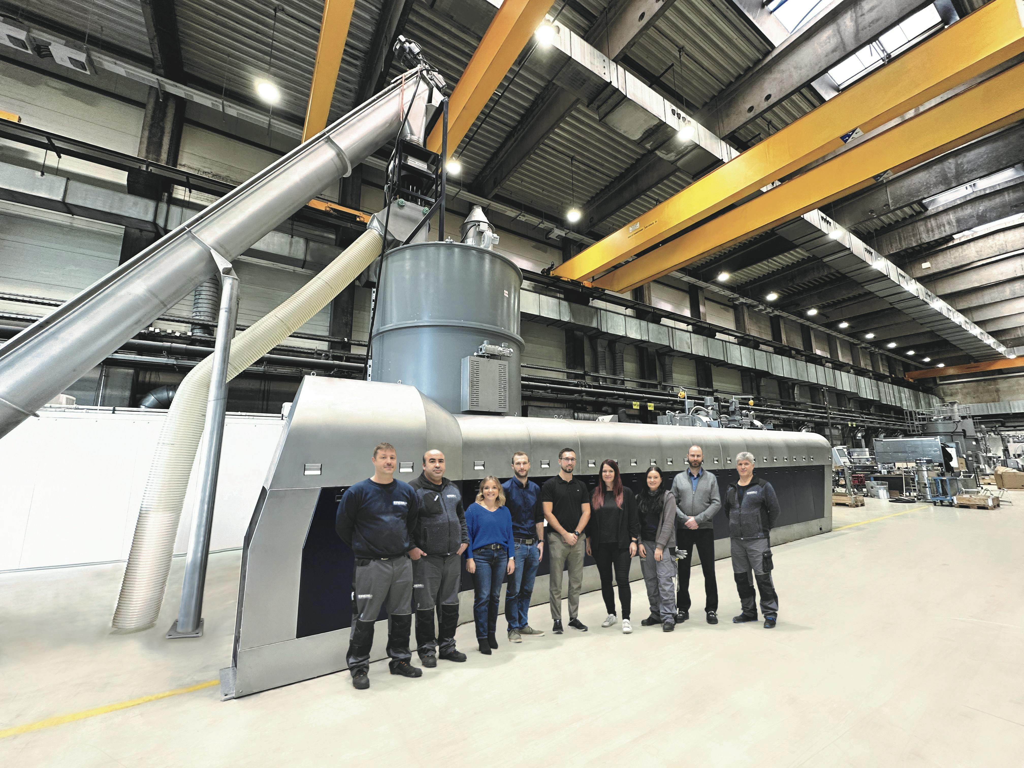 Erema's Intarema 2325 T-VEplus RegrindPro team poses in front of the new recycling system.