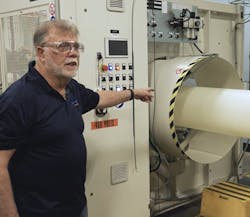 Artie Riegger, a regional sales manager for extrusion for KraussMaffei, shows off some extrusion equipment. Artie Riegger, a regional sales manager for extrusion for KraussMaffei, shows off some extrusion equipment.