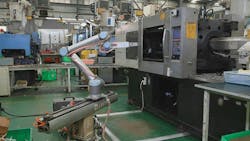 A Universal Robots cobot on a slider tends an injection molding machine at Xiamen Runner Industrial Corp. in China. A Universal Robots cobot on a slider tends an injection molding machine at Xiamen Runner Industrial Corp. in China.