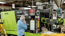 An employee at Hoffer Plastics works on an all-electric Engel e-mac 195 injection molding machine appropriate for making medical devices, electronics and packaging. When it comes to her employees, co-CEO Gretchen Hoffer Farb calls herself a 'mama bear'.