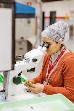A technician performs visual inspection under magnification on plastic injection molded parts at Hoffer Plastics. A technician performs visual inspection under magnification on plastic injection molded parts at Hoffer Plastics.