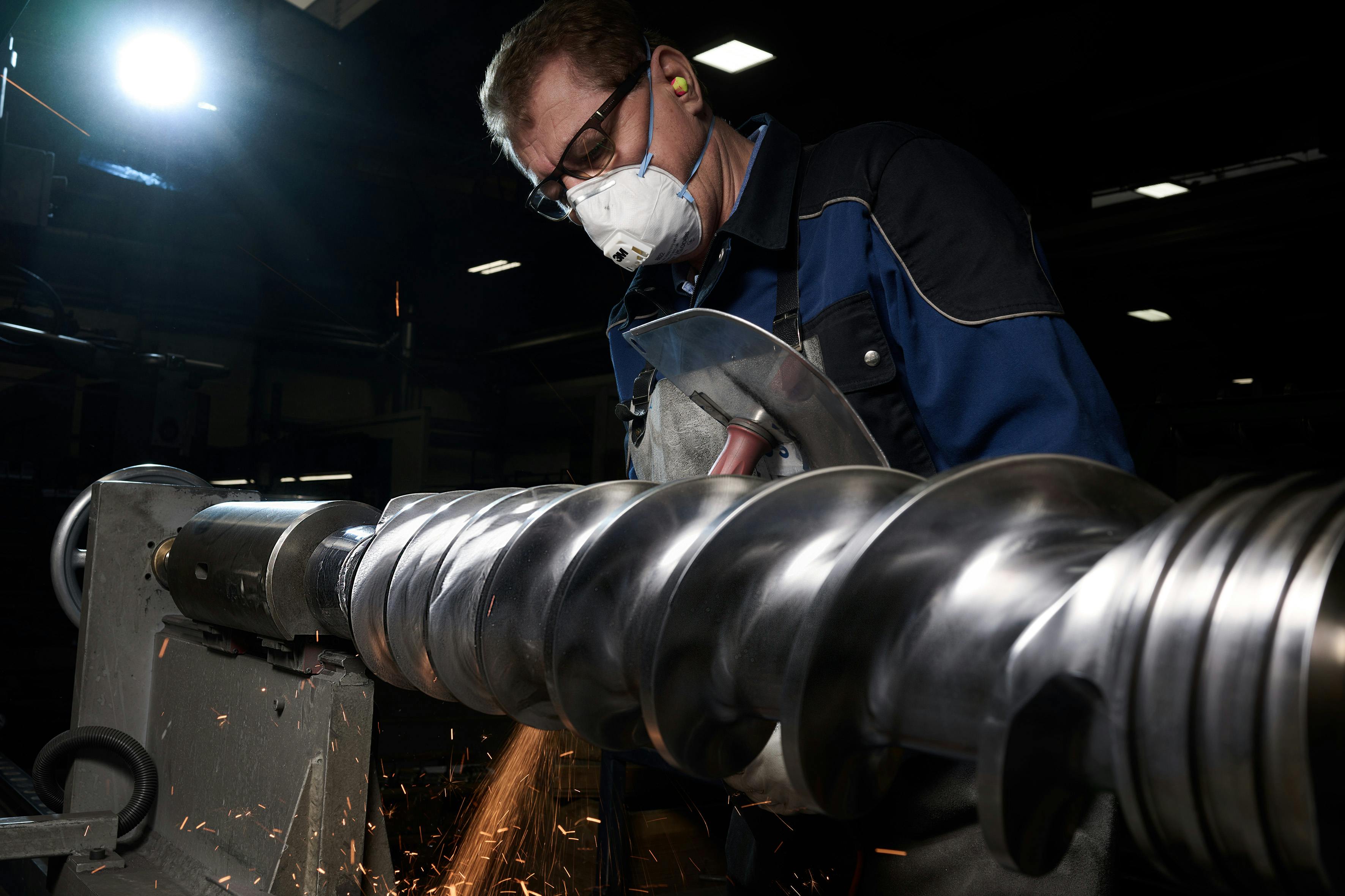 An employee works on an extruder screw at 3S, part of the Erema Group.