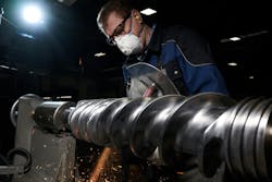 An employee works on an extruder screw at 3S, part of the Erema Group. An employee works on an extruder screw at 3S, part of the Erema Group.