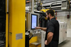 A worker inputs data into the controls of a new LS Mtron machine at Stanford Manufacturing in Clemmons, N.C. A worker inputs data into the controls of a new LS Mtron machine at Stanford Manufacturing in Clemmons, N.C.
