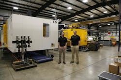 Employees pose next to a new LS Mtron machine at Stanford Manufacturing. Employees pose next to a new LS Mtron machine at Stanford Manufacturing.