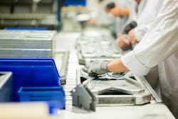 Velocity Group workers on an assembly line insert electronic sensors for an industrial weight sensing application. Velocity Group workers on an assembly line insert electronic sensors for an industrial weight sensing application.