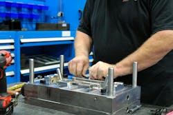 An employee works on building a new mold at Decatur Mold. An employee works on building a new mold at Decatur Mold.