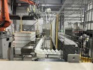 This automatic palletizer is handling 64-ounce bottles on 44-inch by 56-inch pallets. This automatic palletizer is handling 64-ounce bottles on 44-inch by 56-inch pallets.