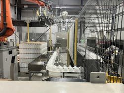 This automatic palletizer is handling 64-ounce bottles on 44-inch by 56-inch pallets. This automatic palletizer is handling 64-ounce bottles on 44-inch by 56-inch pallets.