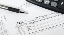 U.S. corporate tax forms, calculator and pen