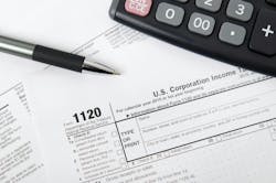 U.S. corporate tax forms, calculator and pen U.S. corporate tax forms, calculator and pen