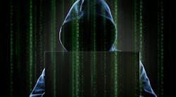 A hooded hacker at a computer. A hooded hacker at a computer.