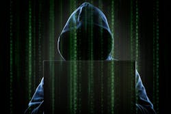 A hooded hacker at a computer. A hooded hacker at a computer.