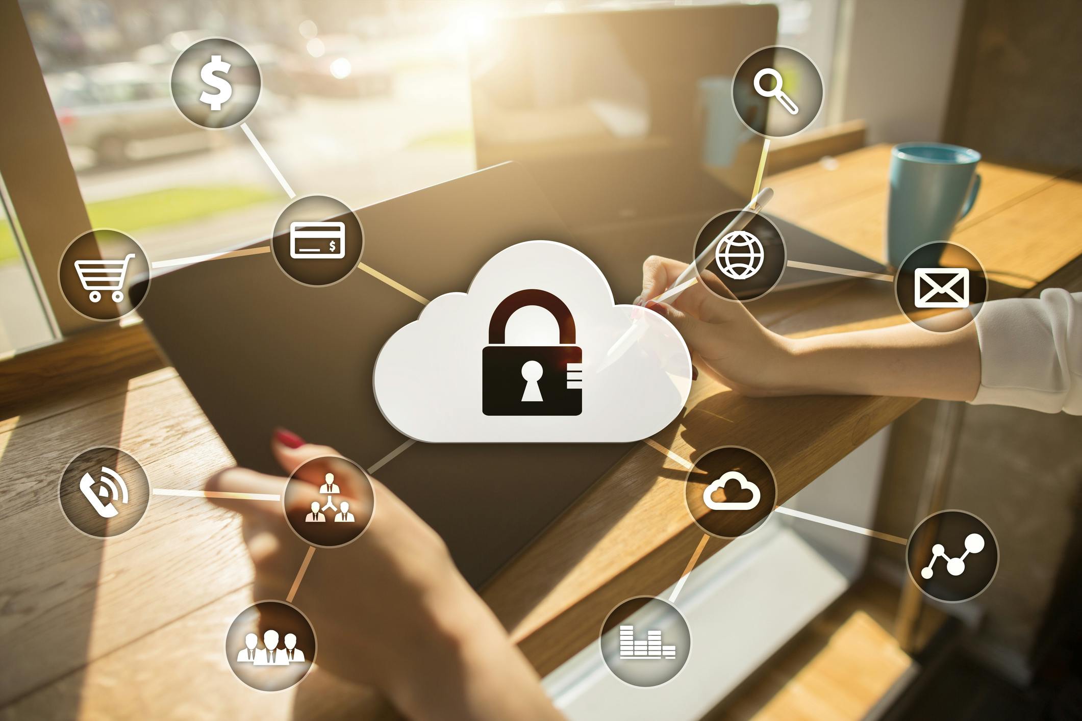 Woman's hands holding tablet overlaid with cybersecurity icons
