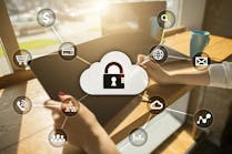 Woman's hands holding tablet overlaid with cybersecurity icons Woman's hands holding tablet overlaid with cybersecurity icons