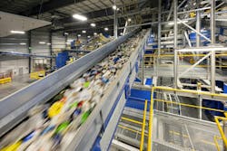 Recyclable material speeds on a conveyor line at the Indianapolis Polymer Center. Recyclable material speeds on a conveyor line at the Indianapolis Polymer Center.