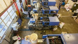 Injection molding machines on a shop floor. Injection molding machines on a shop floor.