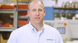Jason Sears on shop floor in blue shirt
