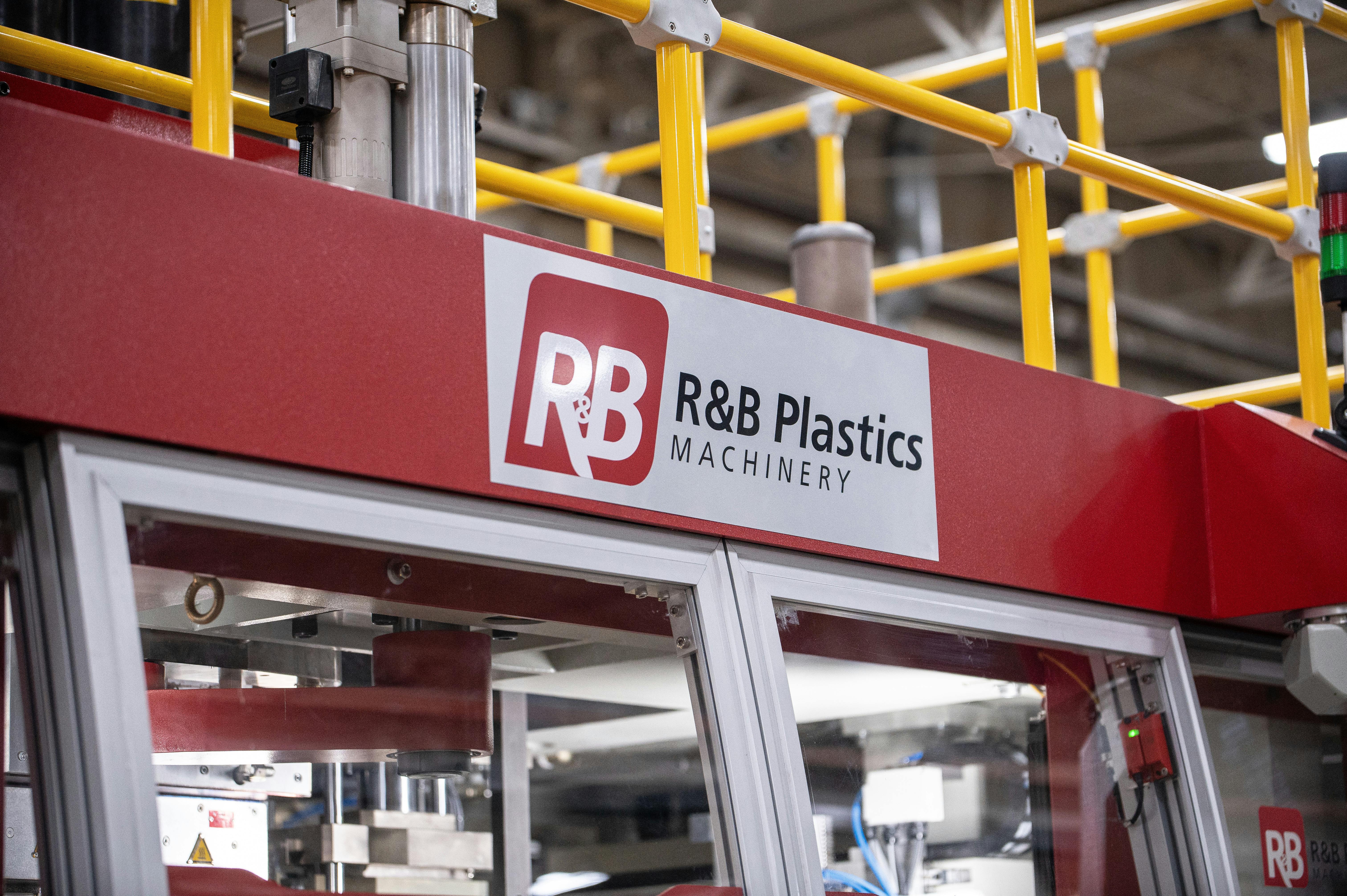 The R&amp;B logo on a red blow molding machine.