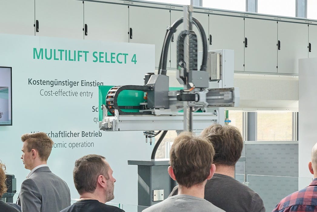 Arburg's Multilift Select 4 industrial robot in a display booth.