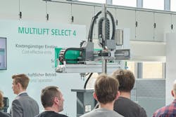 Arburg's Multilift Select 4 industrial robot in a display booth. Arburg's Multilift Select 4 industrial robot in a display booth.