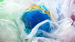 A globe surrounded by plastic bags symbolizes the world's plastic pollution problem.