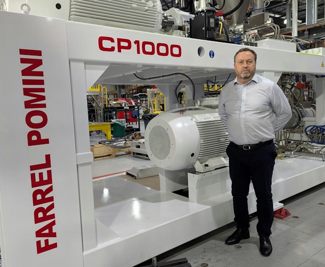 Paul Lloyd, president of Farrel Pomini, with one of his company's CP1000 continuous mixers.